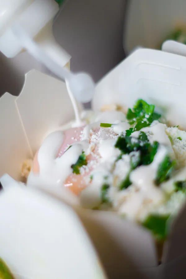 Pouring sauce on chilaquiles